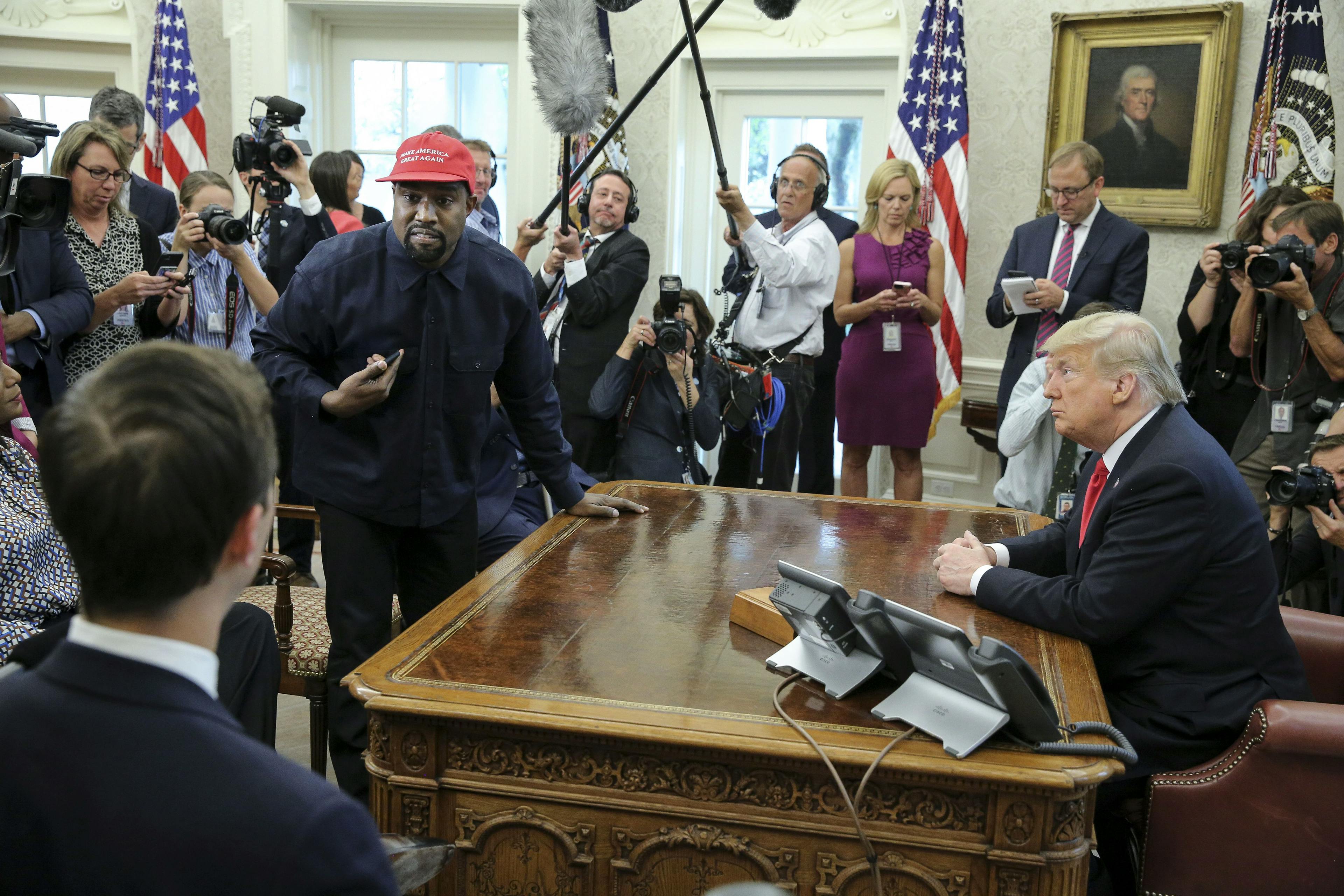 Rapper Kanye West stands up as he speaks during a meeting with U.S. President Donald Trump in the Oval office of the White House on October 11, 2018 in Washington, DC. (Photo by Oliver Contreras - Pool/Getty Images)